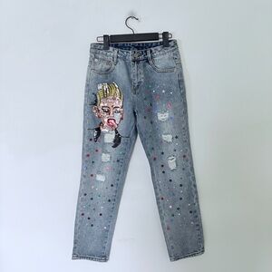 NWOT light-wash distressed jeans feature a distinct sequin-embellished character